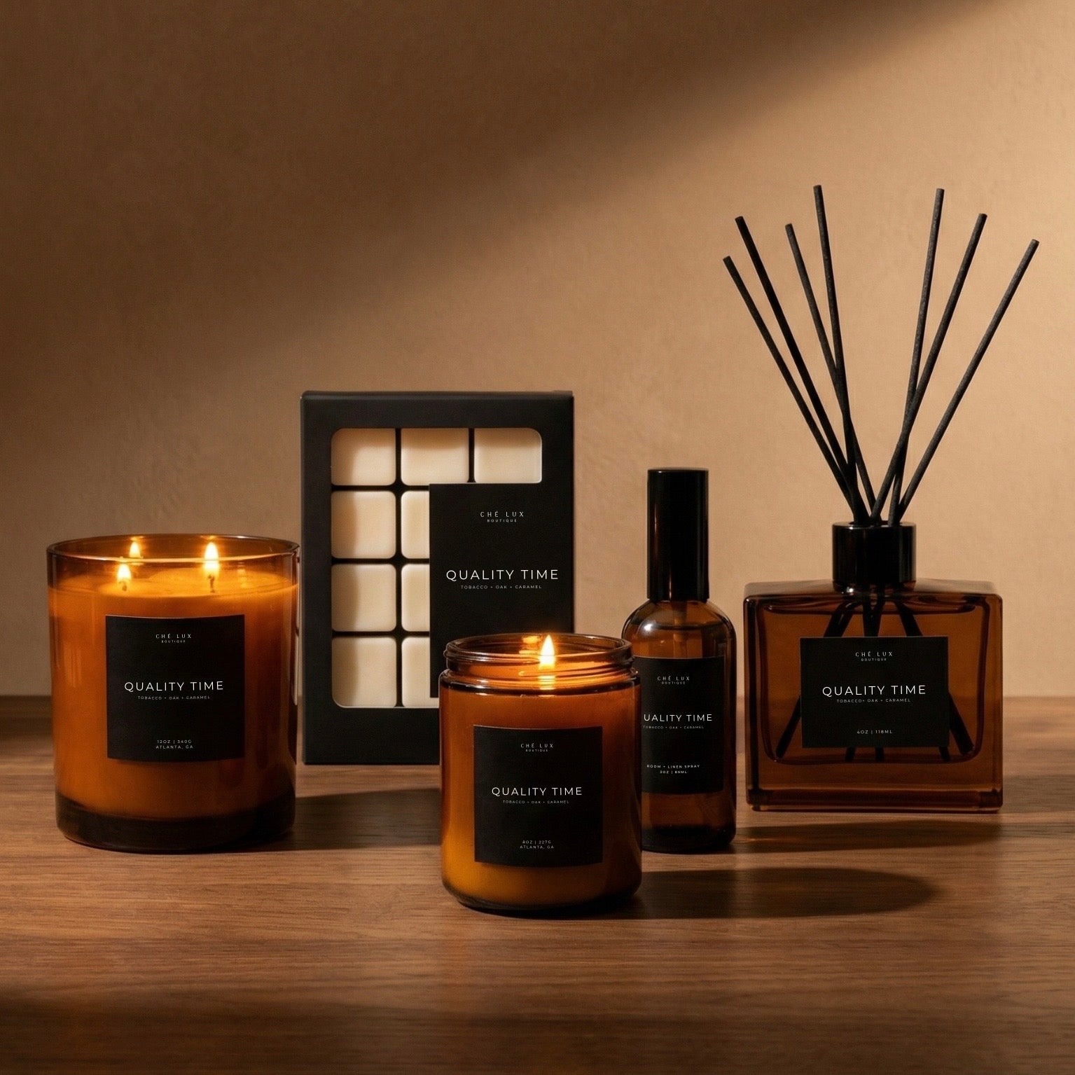 Candle and diffuser set with 'Quality Time' label on a wooden surface.